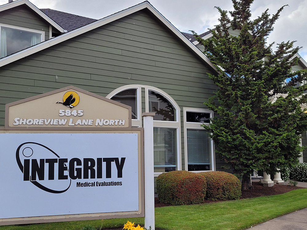 Integrity Medical Evaluations Sign in front of a sage green building inland shores Keizer